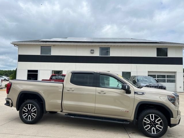 2022 GMC Sierra 1500 AT4 in Desert Sand Metallic — front three-quarter view